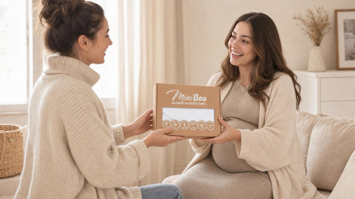 An expecting mother holding a MiniBoo gift set.